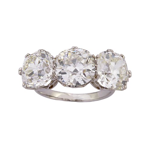 Three stone cushion cut diamond ring, claw set, of approximately 2.40ct, 2.55ct and 2.45ct,